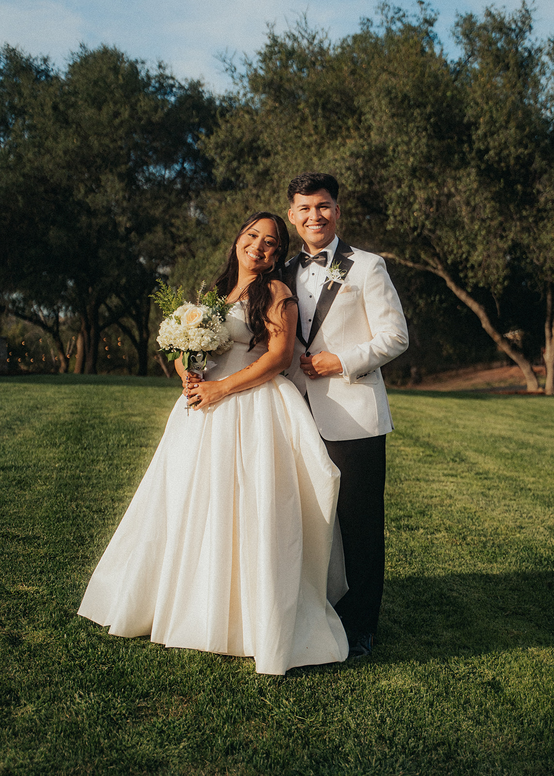 Bride and groom on their wedding day with soft glam bridal makeup by Maddy Donohue
